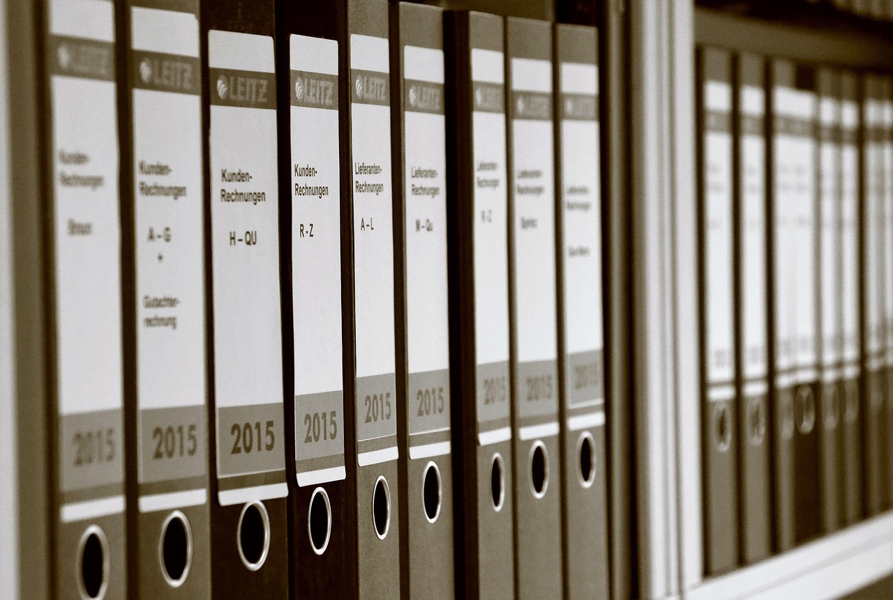 Rangée de classeurs d'archives étiquetés sur une étagère
